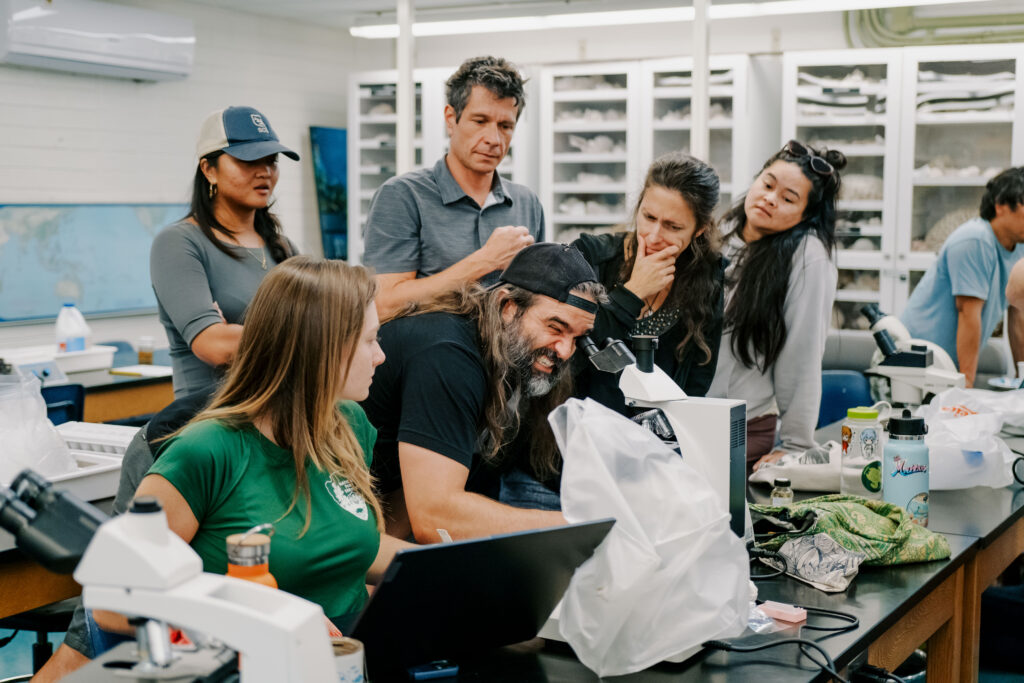 Jan Vicente, Ph.D., researcher at the University of Hawaii, Manoa’s ToBo Lab, demonstrates basic sea sponge identification methods through a microscope.