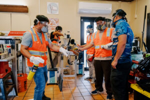 Ernesto Guades, Ph.D., an assistant professor at the University of Guam School of Engineering, works with COMPASS NextGen undergraduate interns to prepare a plastic lumber prototype using an extruder machine at the Guam Green Growth (G3) Circular Economy Makerspace & Innovation Hub.