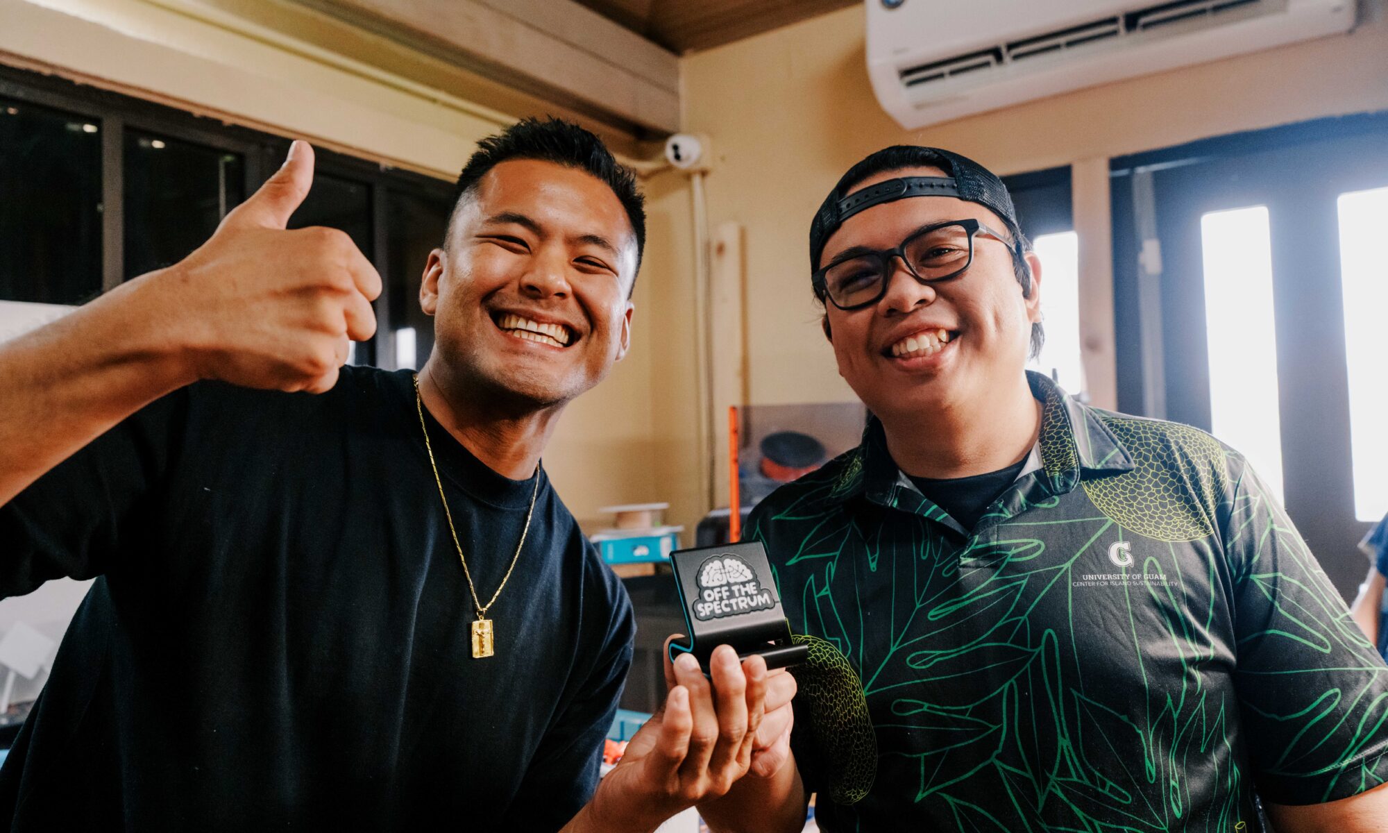 Anthony Cruz, left, and Shawn Garcia, right, holding a phone stand